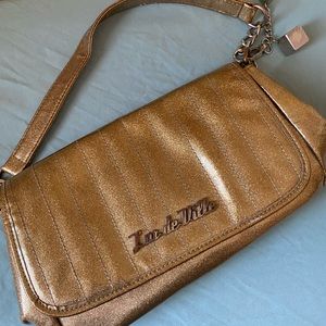 Lux de Ville gold glitter bag with charms.